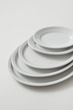 Professional Quality white Protel Platter 11 3/8 in - Set 12  by Porcelain Schmidt. Flat plates with a small flap, which gives additional resistance to the pieces.